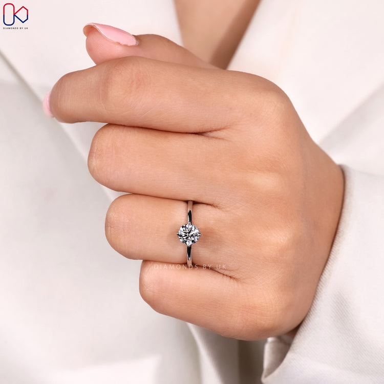 Solitaire setting engagement ring with round cut diamond.
