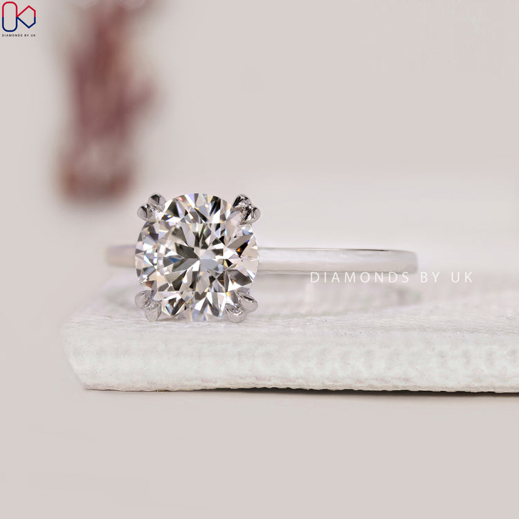 Simple engagement ring featuring a round solitaire diamond.
