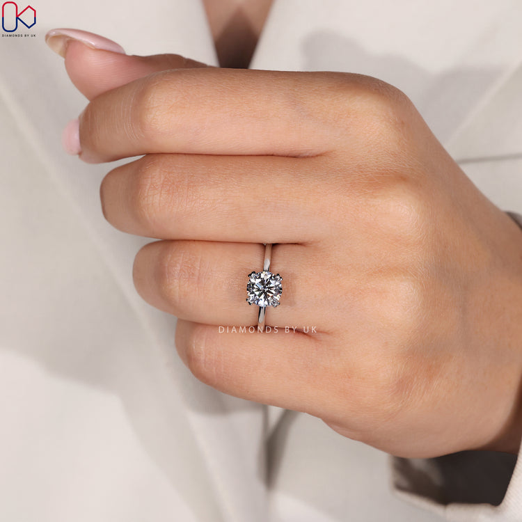 Double claw prong engagement ring with a round diamond.
