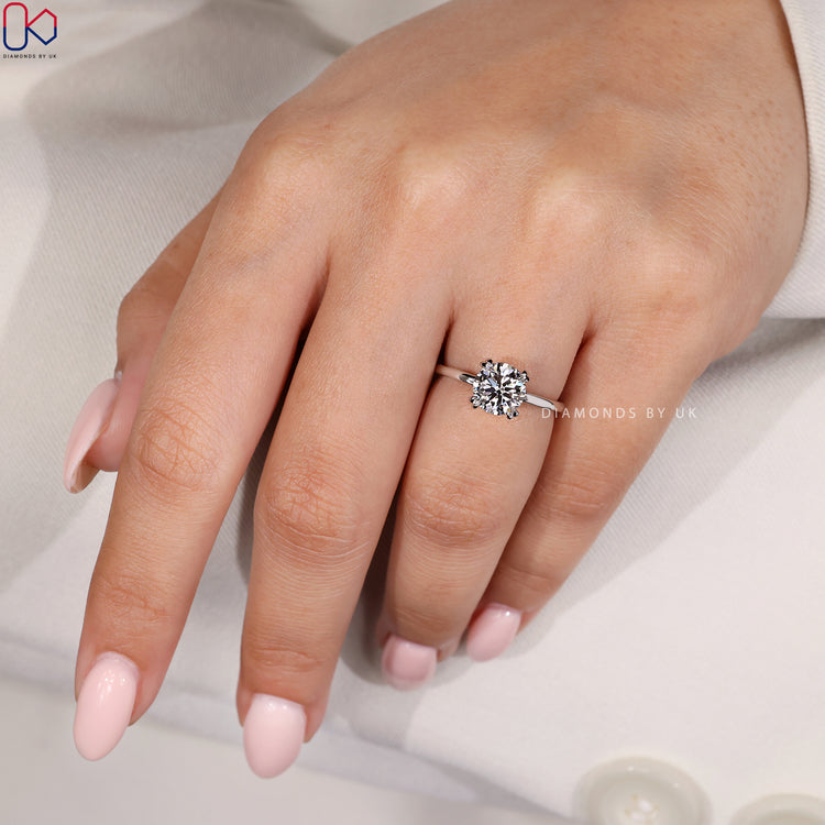 Handmade ring featuring a round engagement diamond.
