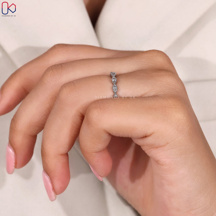 Marquise shape outline band with diamond accents.
