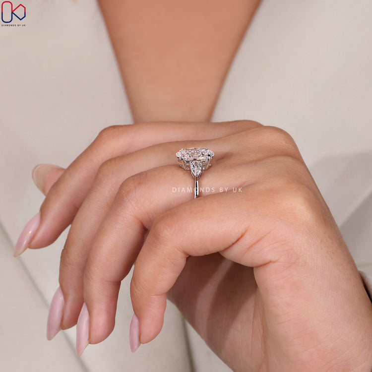 White gold ring with a three-stone arrangement.
