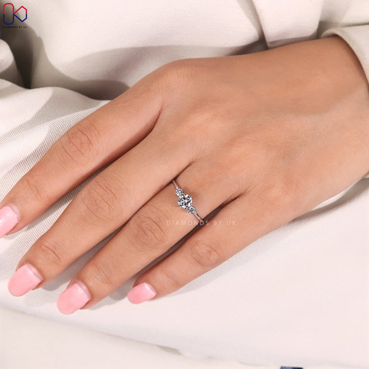 Round diamond engagement ring with three stone design.
