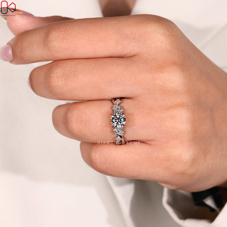 Round and marquise side stone engagement ring.
