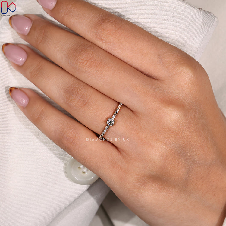 Handmade jewelry with round diamond and delicate pave band.
