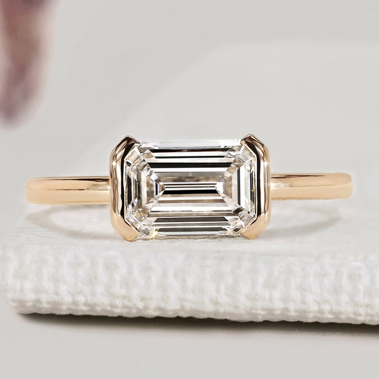Emerald cut diamond ring with half bezel setting