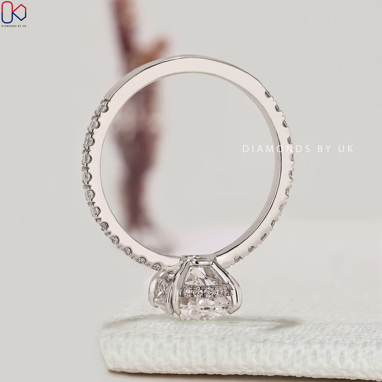 IGI certified oval diamond ring with round pavé diamonds.
