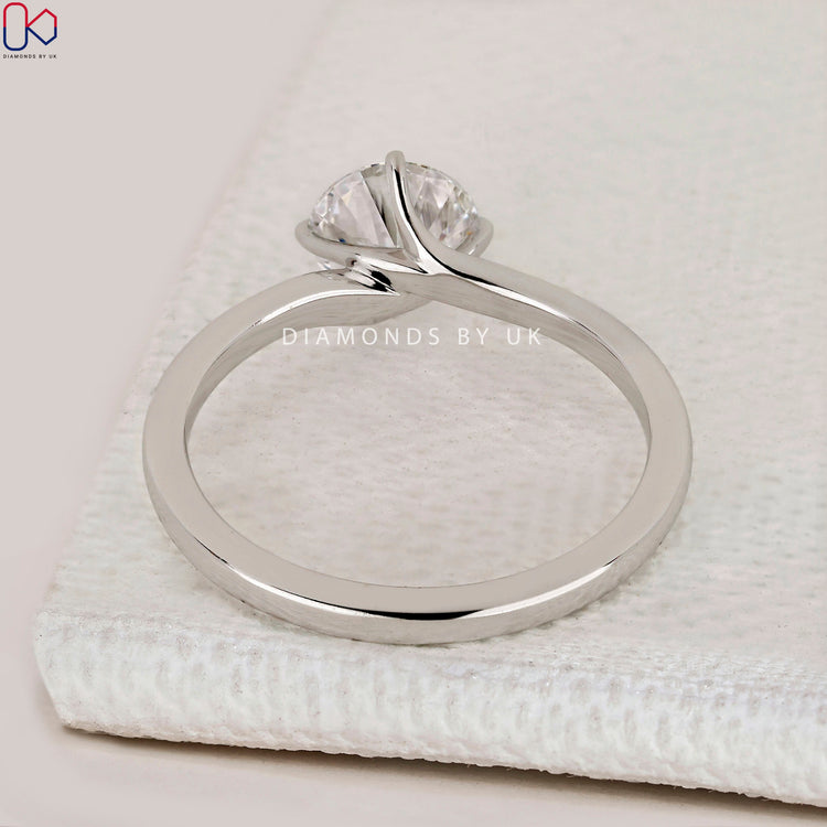 Handmade round cut ring with compass prong setting.