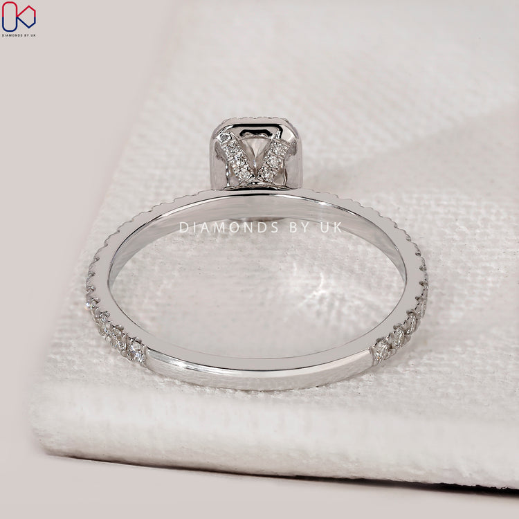 Radiant cut ring with hidden accent and pavé band.