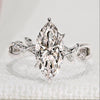 Marquise cut engagement ring with round side stones.
