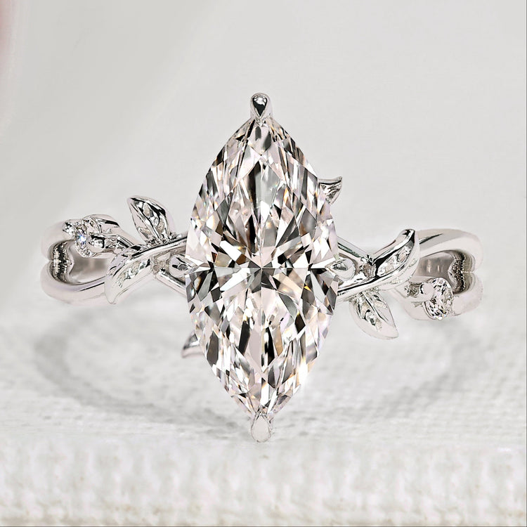 Marquise cut engagement ring with round side stones.

