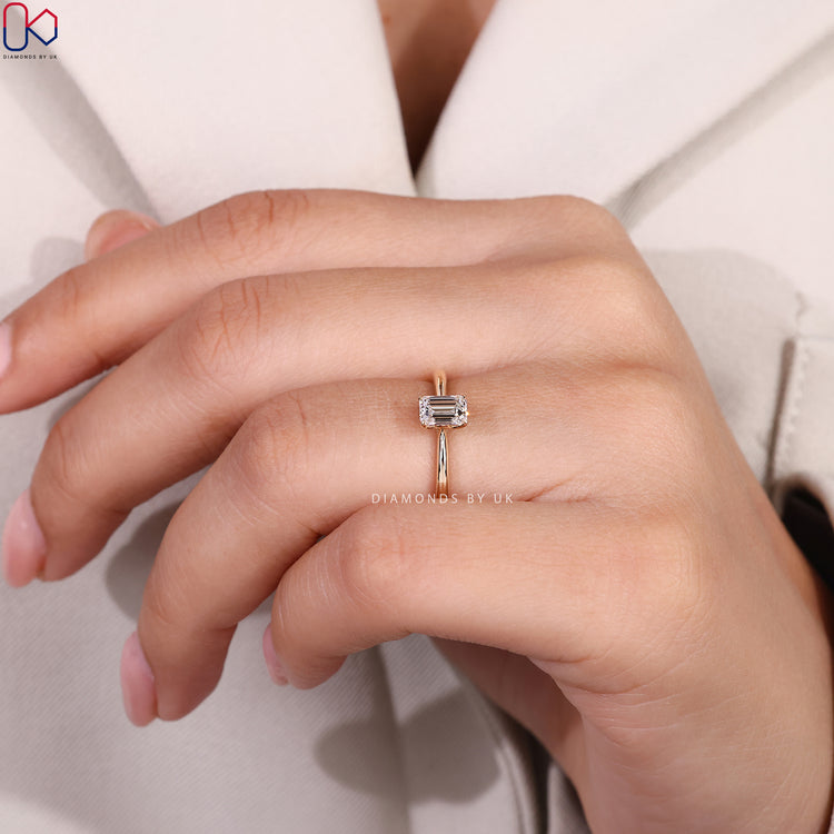 Lab grown emerald cut solitaire engagement ring.