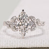 Marquise cut diamond ring with round diamond side stones.
