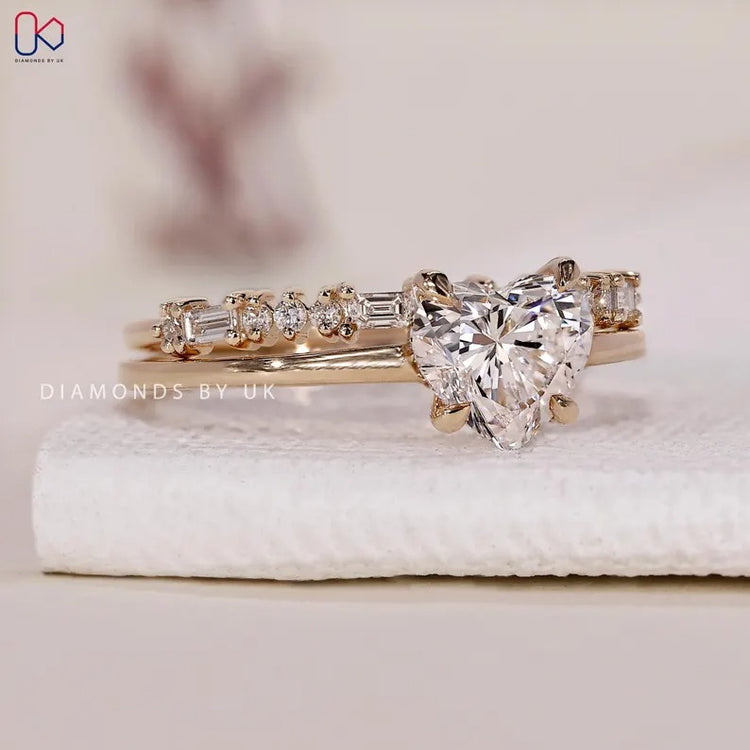Heart cut engagement ring with round diamond halo.