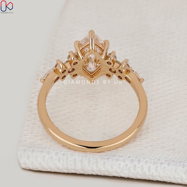 Marquise ring with claw prong side stone setting.
