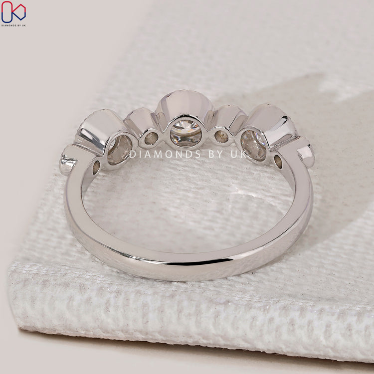 Round diamond wedding band with milgrain bezel setting.

