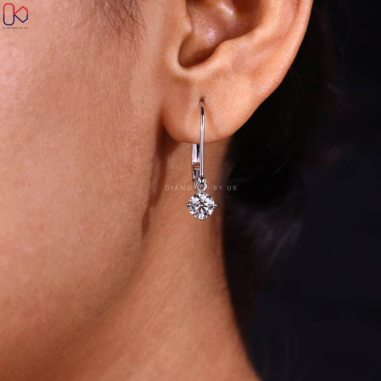 Round diamond earrings with compass prong setting.