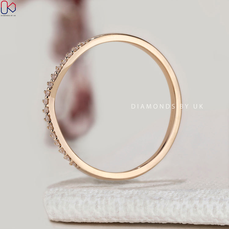 Round diamond band with curved half eternity style.