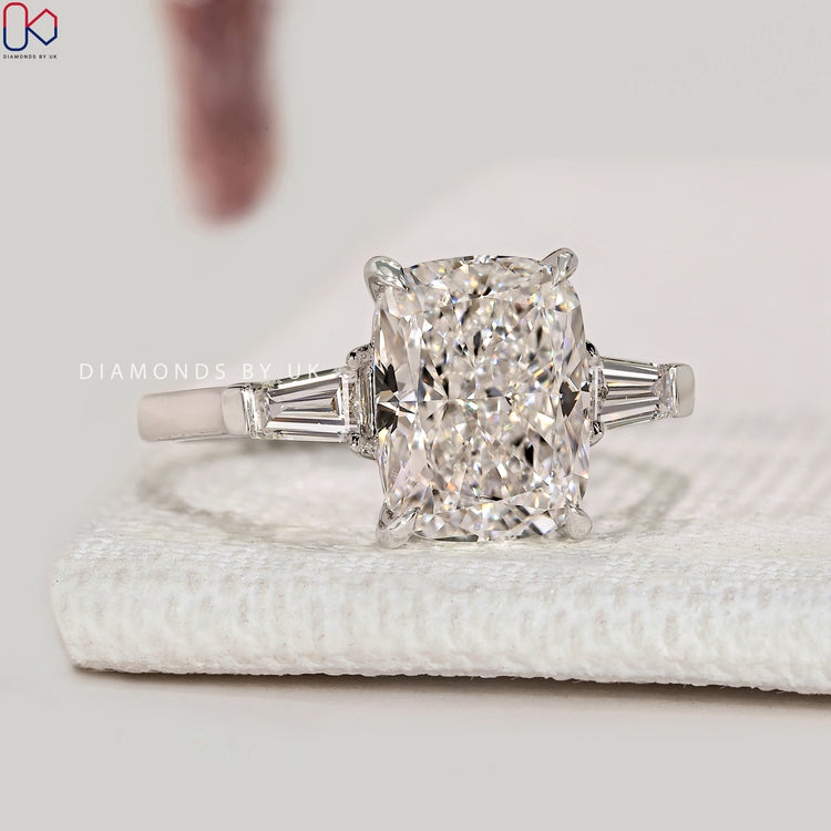 Cushion cut ring with tapered baguette side stones.
