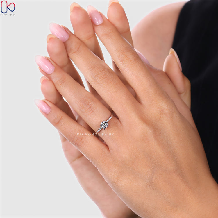 Round diamond engagement ring by Diamondsbyuk with pavé.
