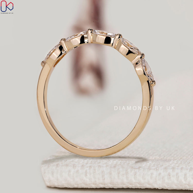 Marquise half eternity band with shared prongs.