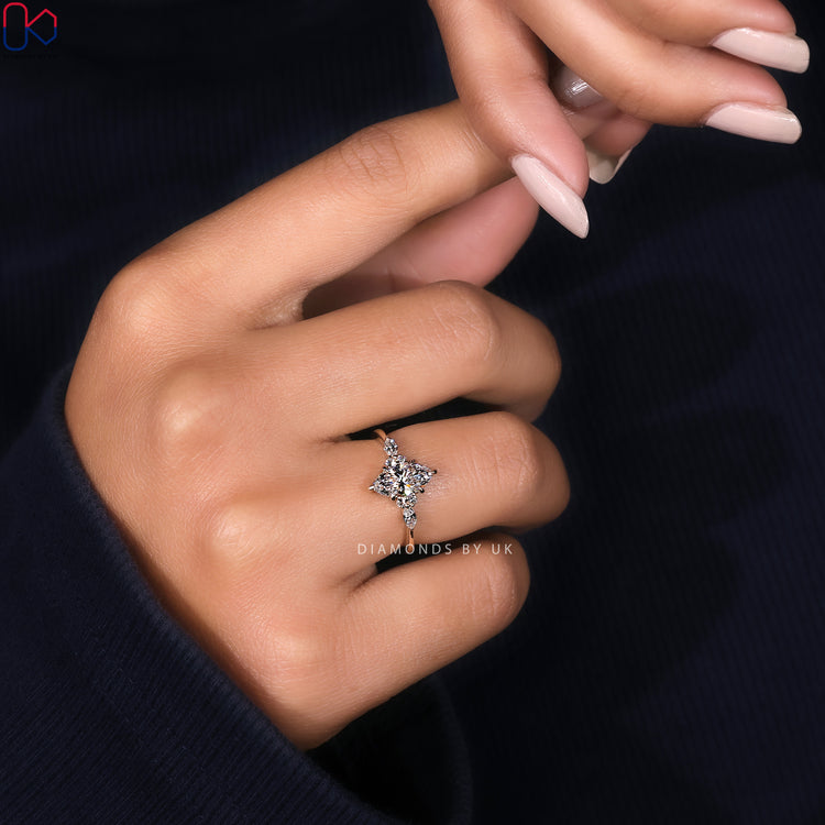 Muse setting marquise cut ring with side stones.