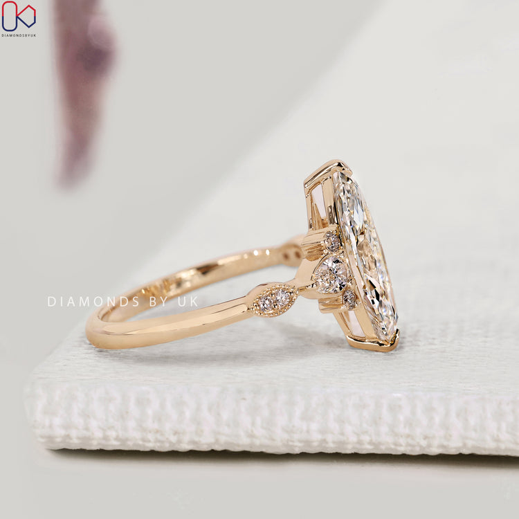 Handmade marquise diamond ring with pear side stones.
