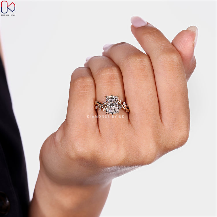 Radiant cut ring with marquise stones and leaf prongs.
