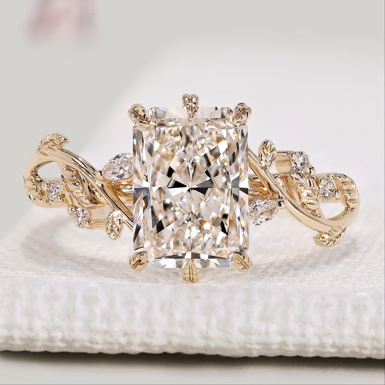 Radiant cut diamond ring with marquise and round side stones.