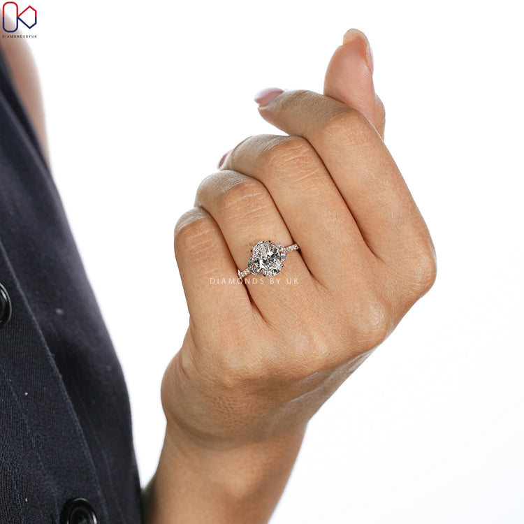 Oval cut engagement ring with marquise side stone style.
