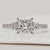 Princess cut ring with pear side stones and pavé.