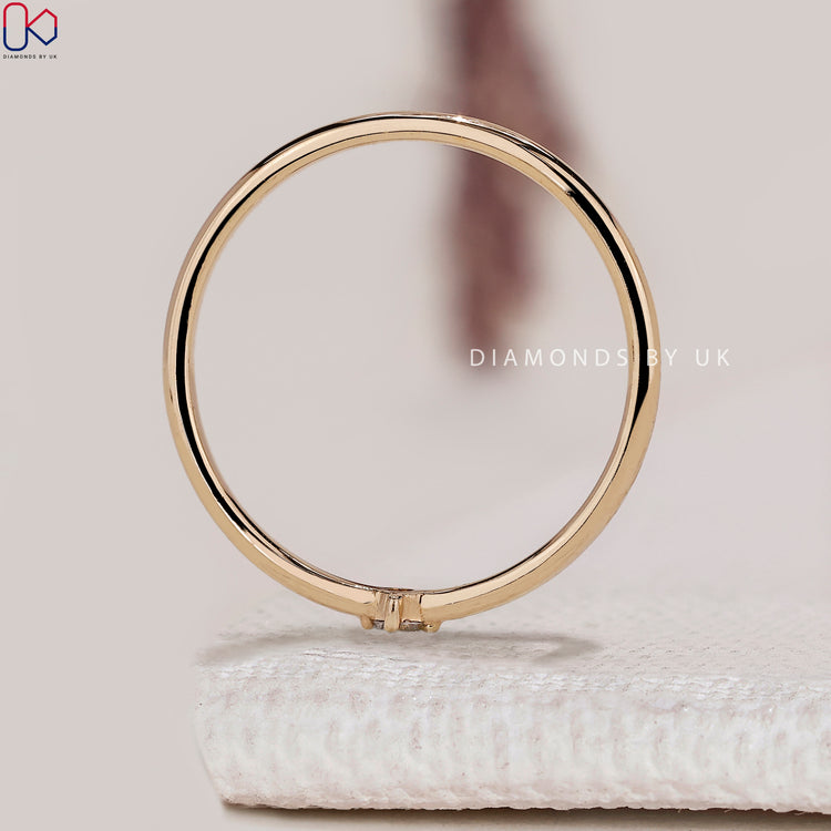 Round diamond wedding band with minimalist design.
