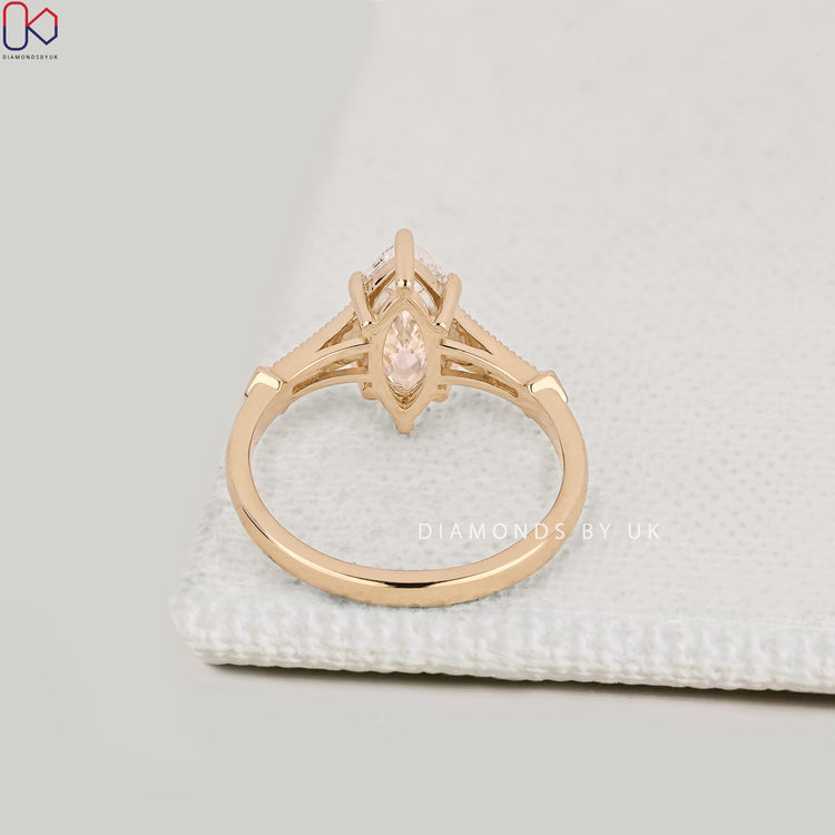 Lab grown marquise diamond ring with hidden halo style.
