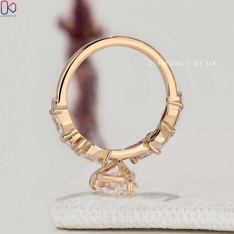 IGI certified pear diamond ring with side stones.
