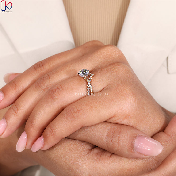 Hidden halo ring with twisted pavé diamond band.