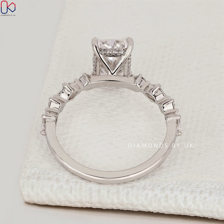 Radiant cut ring with shared prong pavé and halo style.
