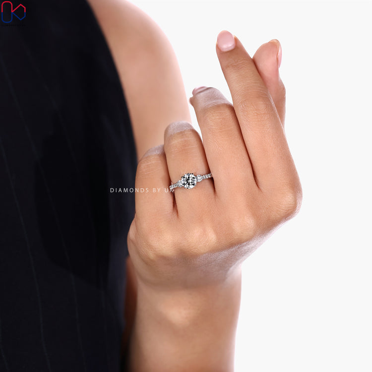 Three stone round ring with cathedral setting.