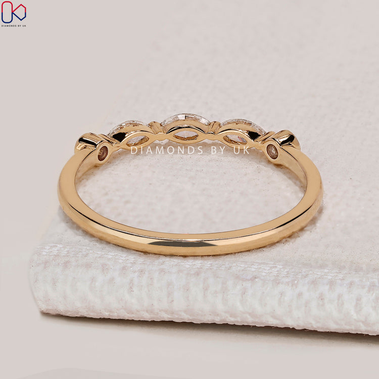 Handmade marquise and round diamond band with five stones.
