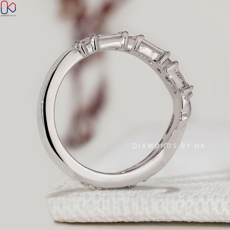 Baguette and round diamond band with curved design.