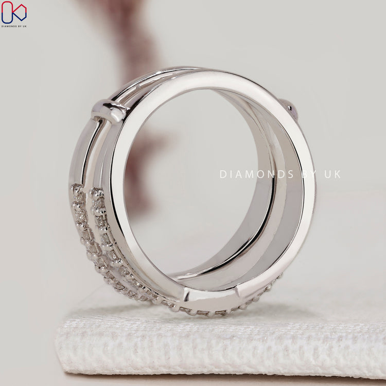 Round diamond wedding band with enhancer wrap guard.
