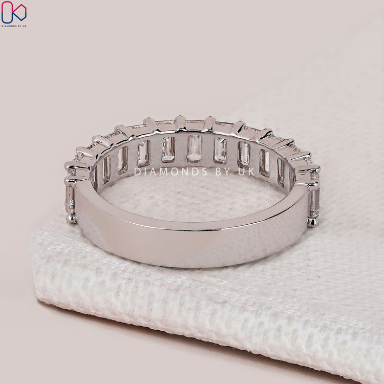 Handmade emerald cut diamond band with prong setting.