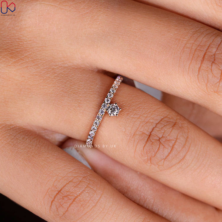 Round cut eternity diamond band with claw prongs.
