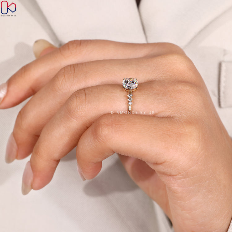 Muse setting round cut ring with side stones.