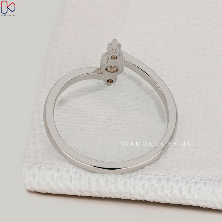 Handmade three stone ring with round diamond.
