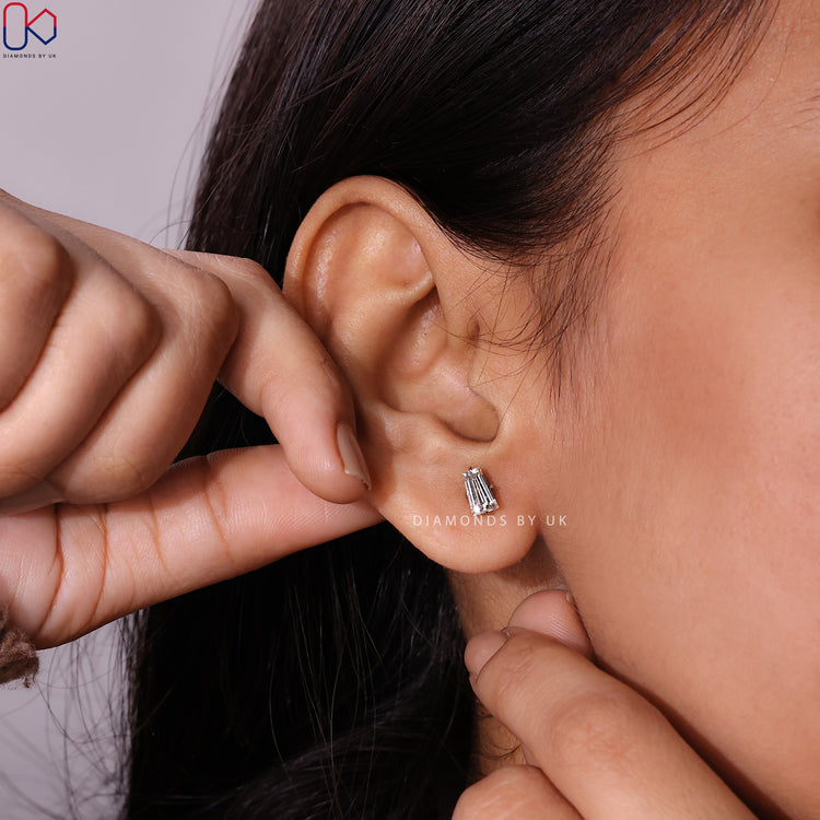 Tapered baguette stud earrings with compass setting.