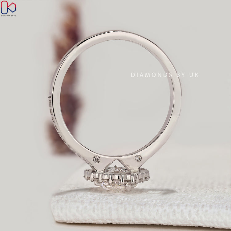 Pear ring with round diamond halo and pavé.