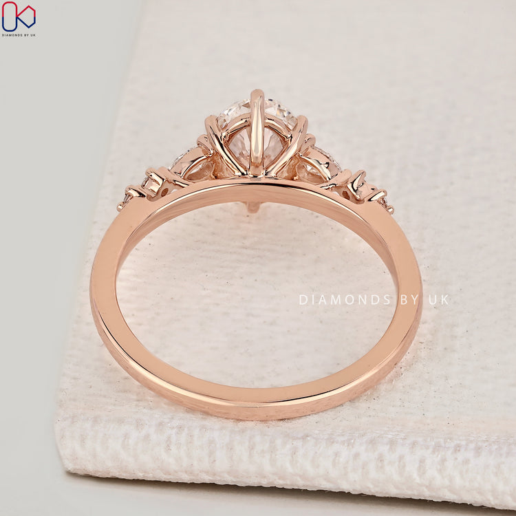 Handmade oval diamond ring with pear side stones.
