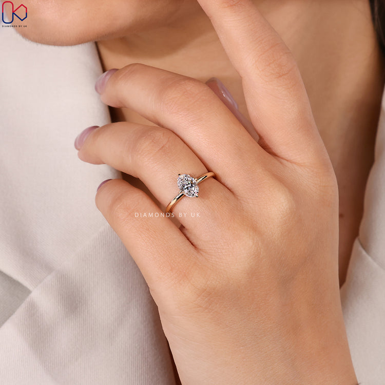 Compass prong oval cut ring with IGI diamond.