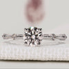 Round diamond engagement ring with pavé band style.