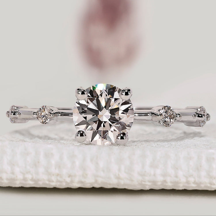 Round diamond engagement ring with pavé band style.